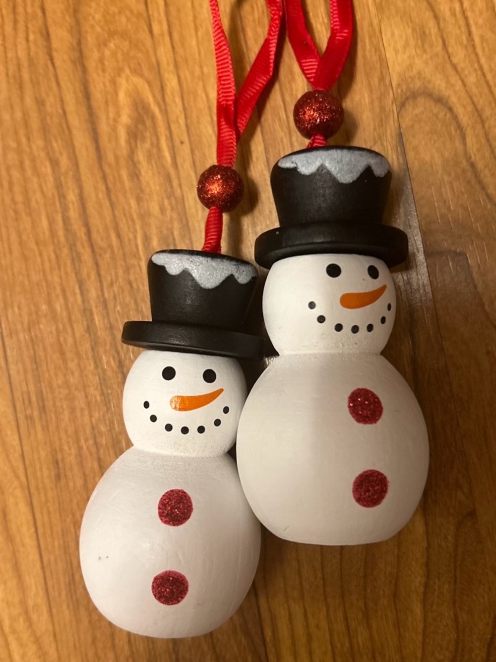 Pair of White Snowman Hanging Ornaments with Black Hats and Red Accents